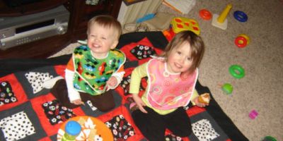Little brother and big sister enjoy an indoor picnic