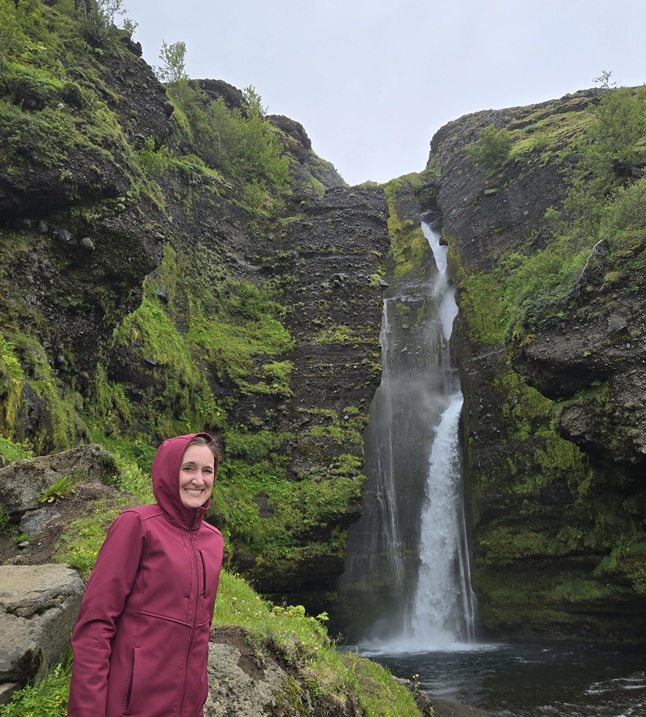 Mama O. stands next to Gluggafoss waterfall